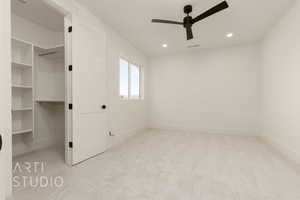 Empty room with ceiling fan and light carpet