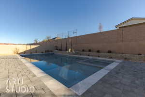 View of swimming pool with an in ground hot tub