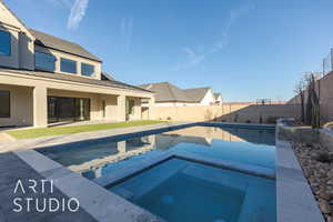 View of swimming pool with an in ground hot tub