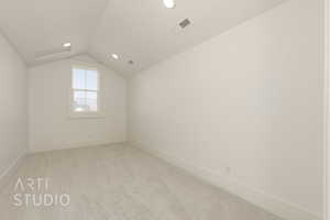 Additional living space featuring lofted ceiling