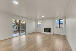 Living room that steps down from the kitchen with fireplace and sliding patio door