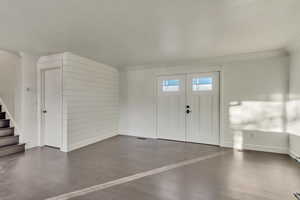 Entrance foyer featuring ornamental molding, main floor living room area