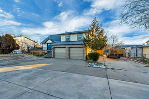 View of front of property featuring a deck and a garage