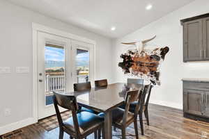 Dining area featuring dark hardwood / wood-style floors and vaulted ceiling