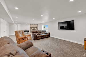 Living room featuring a fireplace and light carpet