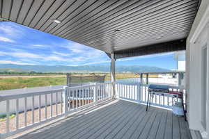 Wooden terrace with a mountain view and a grill