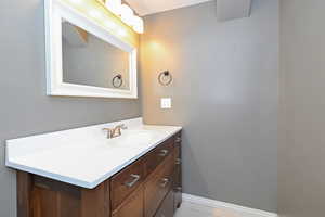Bathroom featuring vanity, baseboards, and tile patterned flooring