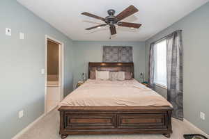 Carpeted bedroom with ceiling fan