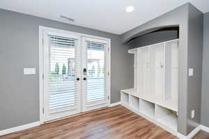 Mudroom featuring baseboards, french doors, wood finished floors, and recessed lighting