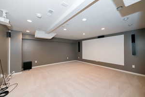 Cinema room with light carpet, recessed lighting, and baseboards