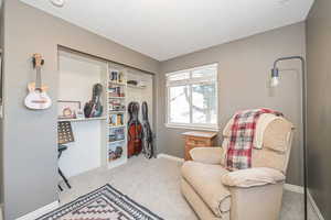 Sitting room featuring light carpet