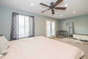 Carpeted bedroom with ceiling fan, access to exterior, and french doors