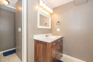 Bathroom featuring tile patterned floors and vanity