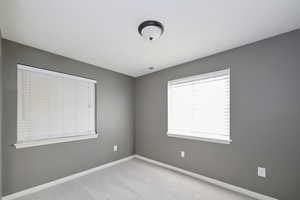 Unfurnished room featuring baseboards and carpet floors