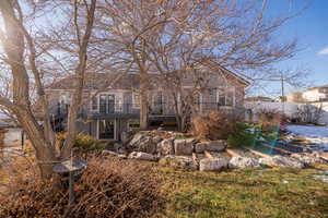 Back of property with a wooden deck