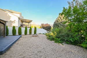 View of yard featuring fence and a deck with mountain view