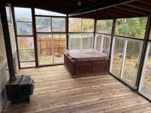 Sunroom featuring plenty of natural light and lofted ceiling