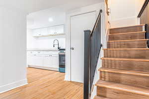 Stairway featuring wood-type flooring