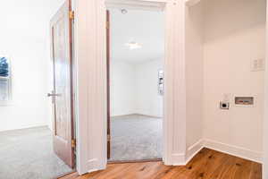 Hallway with hardwood / wood-style flooring