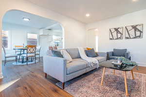 Living room with dark wood-type flooring