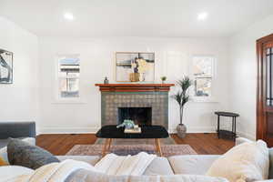 Living room with a fireplace, hardwood / wood-style flooring, and a wealth of natural light