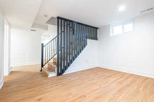 Stairs featuring wood-type flooring