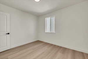 Unfurnished room with light hardwood / wood-style floors