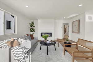 Living room with a fireplace and light hardwood / wood-style floors