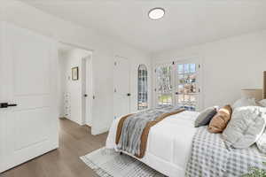 Bedroom with access to outside and light wood-type flooring