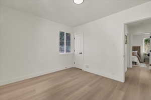 Unfurnished room featuring light wood-type flooring