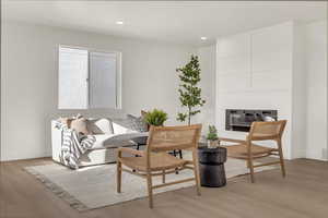 Living room with breakfast area and light wood-type flooring