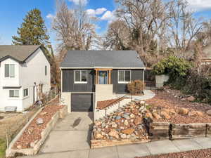 View of front of home featuring a sunroom and a garage