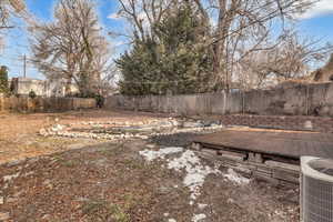 View of yard featuring a deck and cooling unit