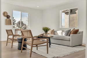 Sitting room with light hardwood / wood-style flooring