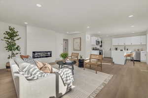 Living room featuring light wood-type flooring and a fireplace