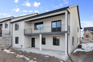 Rear view of house with cooling unit and a patio