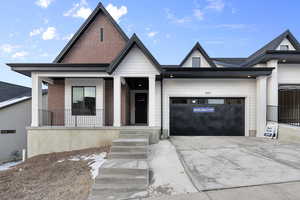 View of front of house with a porch and a garage