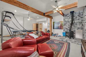 Living room featuring beamed ceiling and ceiling fan