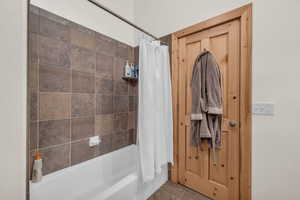 Bathroom with shower / tub combo and tile patterned floors