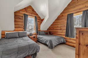 Bedroom with rustic walls and vaulted ceiling