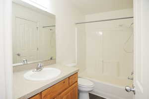 Full bathroom with shower / bathing tub combination, vanity, and toilet