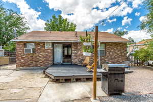 Back of house featuring a patio, cooling unit, and a wooden deck