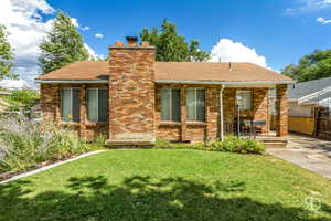 Rear view of property with a yard