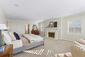 Bedroom with light carpet and ornamental molding