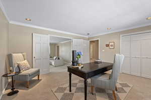 Carpeted home office featuring ornamental molding