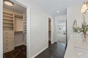 Interior space with dark slate floors and double sinks