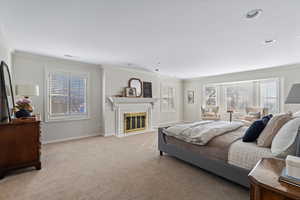 Carpeted bedroom featuring crown molding