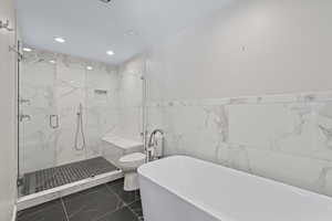 Bathroom featuring independent shower and bath, tile walls, and toilet