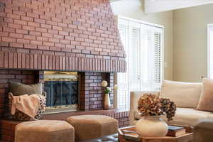 Living room featuring a brick fireplace