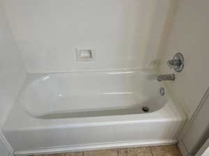 Bathroom featuring a washtub and tile patterned floors